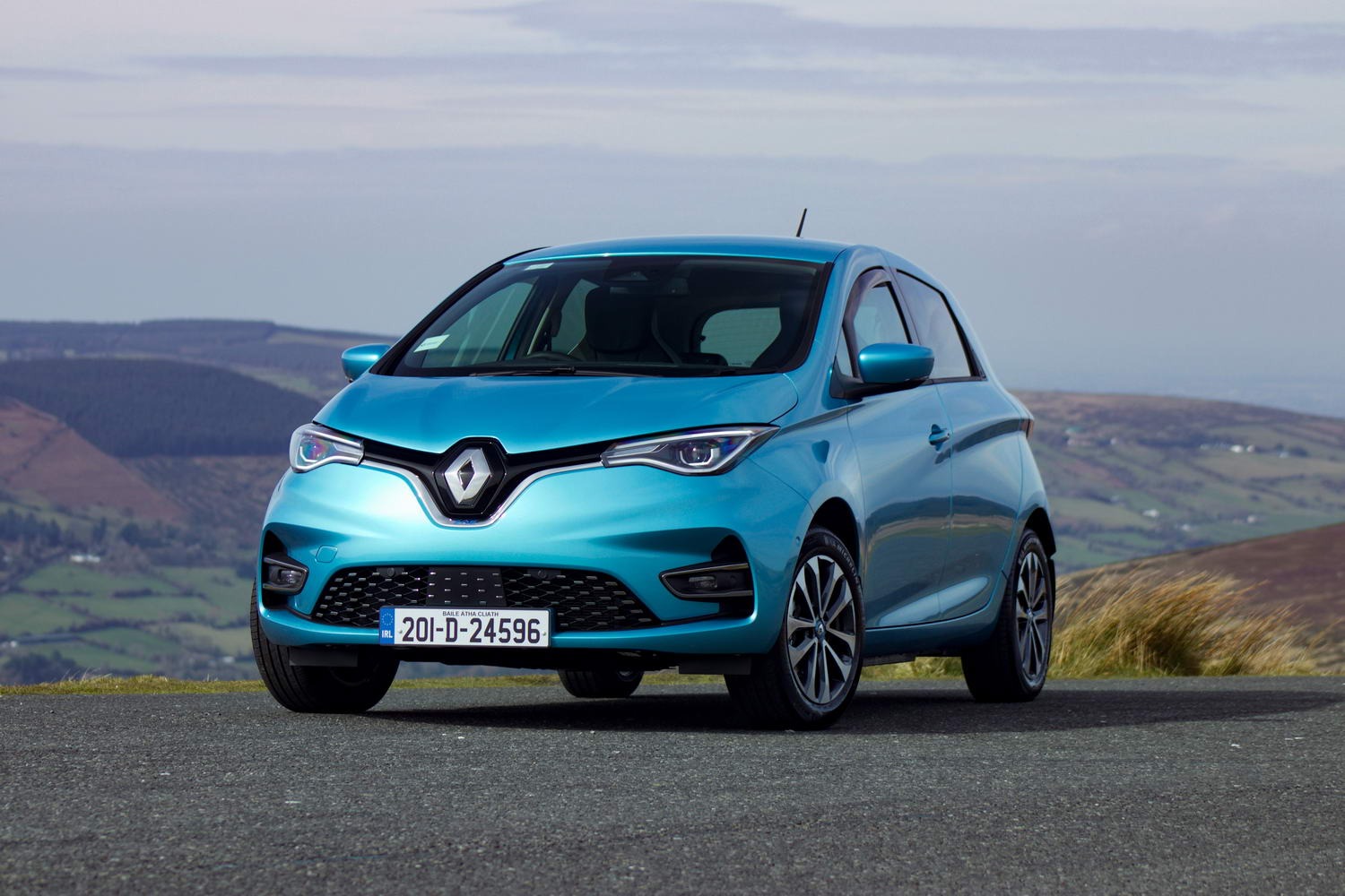 a blue car standing on a mountains background