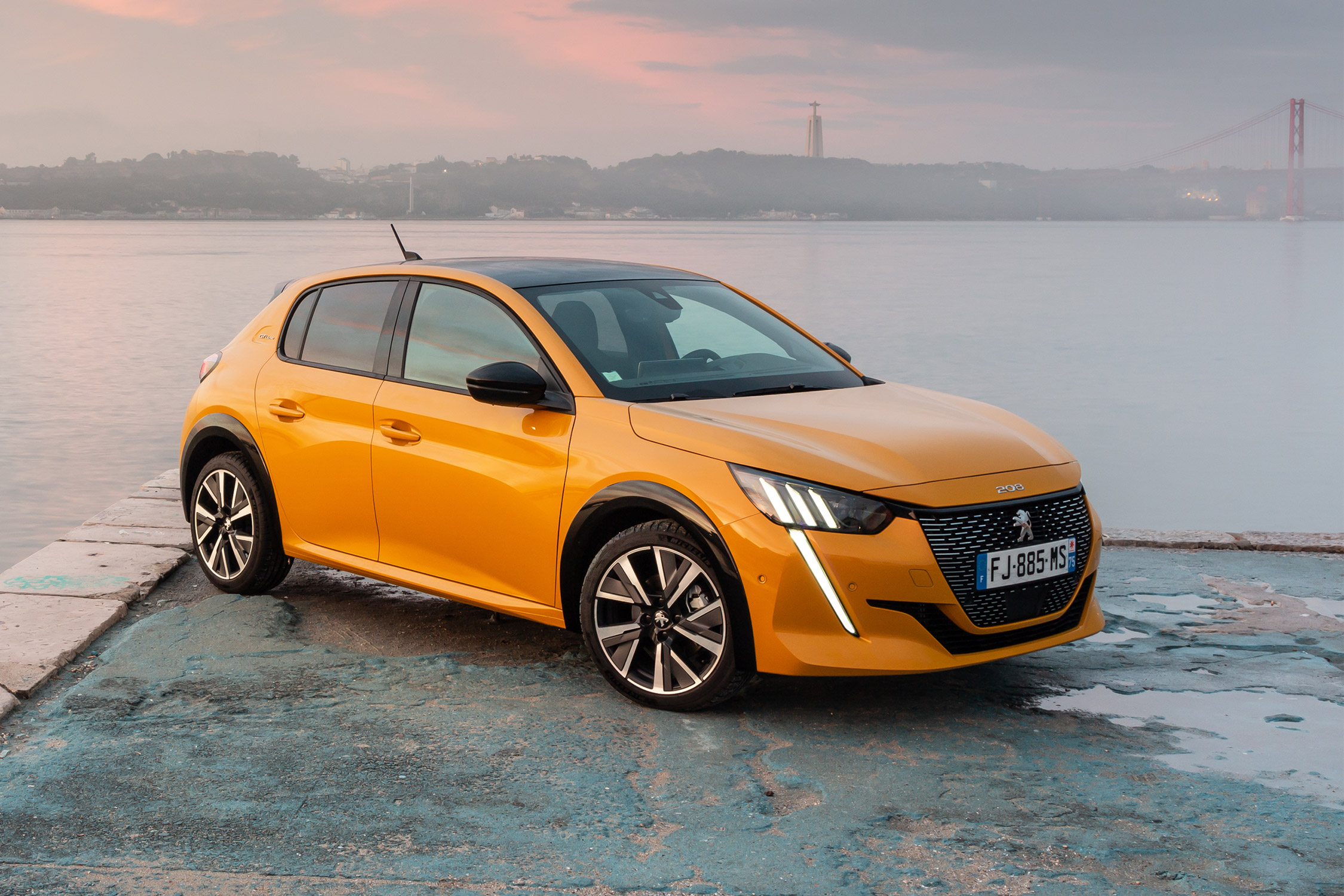 a yellow car standing on a lake background