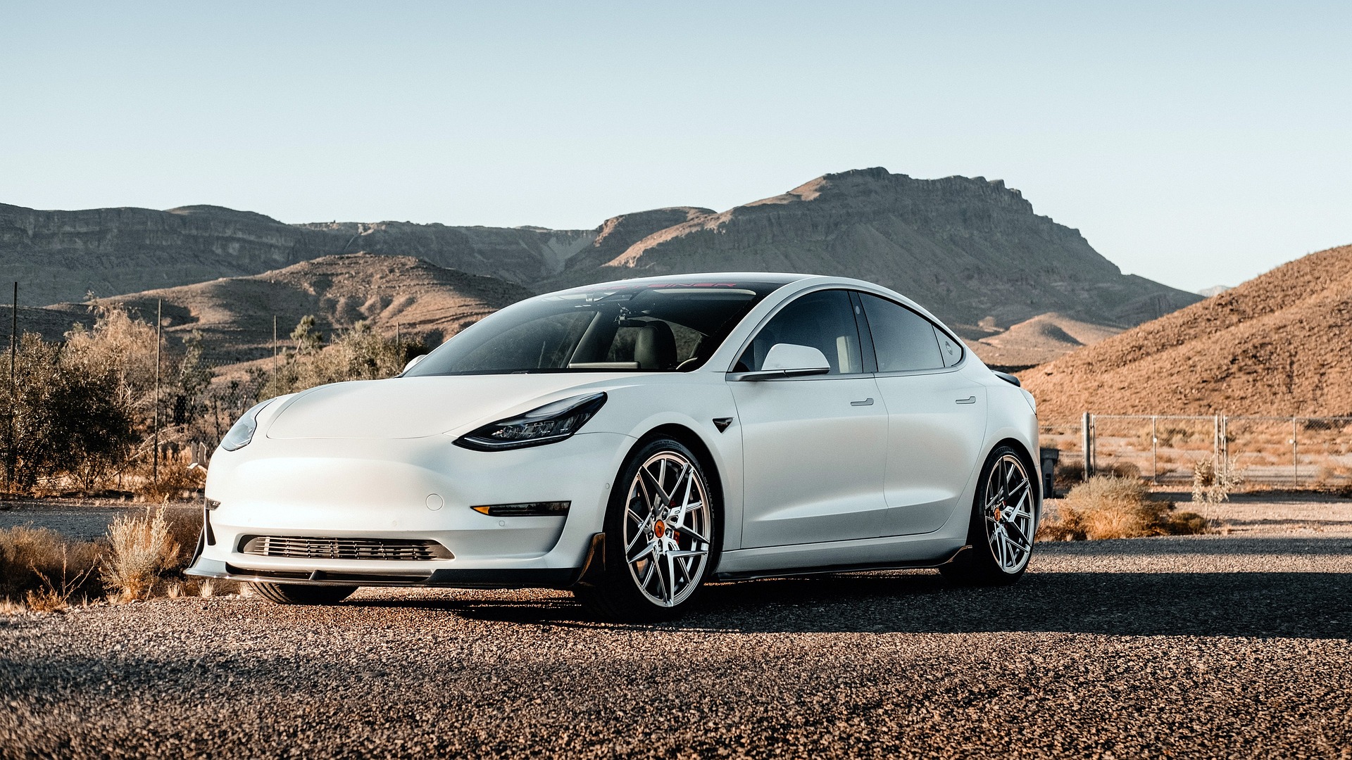 a white car standing in mountains background